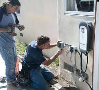 electricians outside fixing wiring
