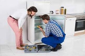 Electrician repairing refrigerator